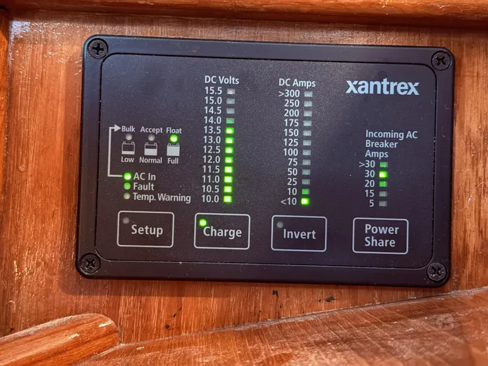 Moonsplash Yacht Photos Pics Xantrex power panel on 1987 Island Packet 38, displaying DC volts, amps, and AC breaker status.
