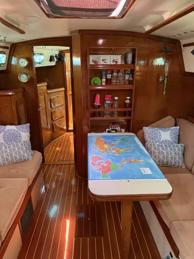 Moonsplash Yacht Photos Pics Interior of 1987 Island Packet 38 sailboat with map on table and cozy seating.