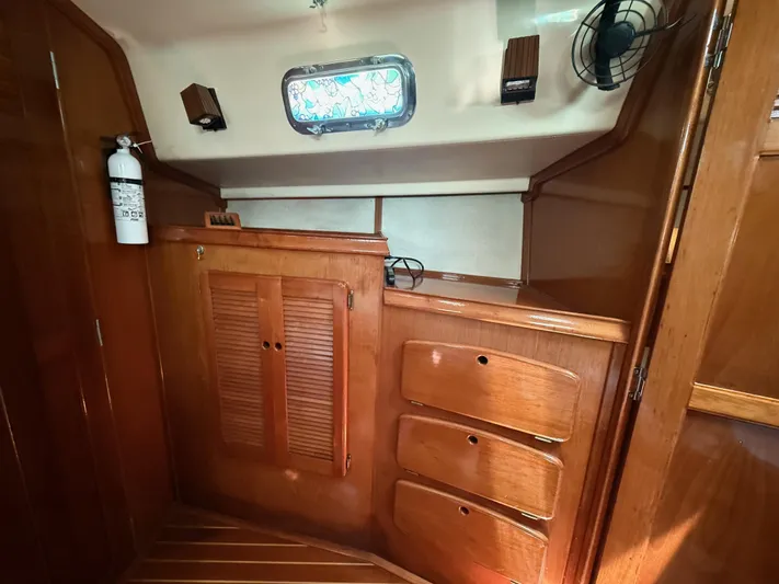 Moonsplash Yacht Photos Pics 1987 Island Packet 38 interior with wooden cabinetry and storage drawers.
