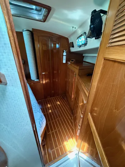 Moonsplash Yacht Photos Pics Interior of 1987 Island Packet 38 sailboat with wooden cabinetry and flooring.