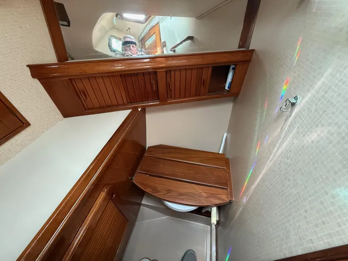 Moonsplash Yacht Photos Pics 1987 Island Packet 38 yacht bathroom with wooden cabinetry and compact design.