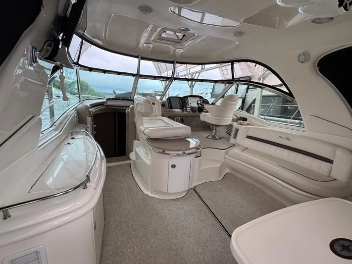 Dani Mar Yacht Photos Pics Luxurious interior of a 2003 Sea Ray 500 Sundancer yacht with plush seating and helm.