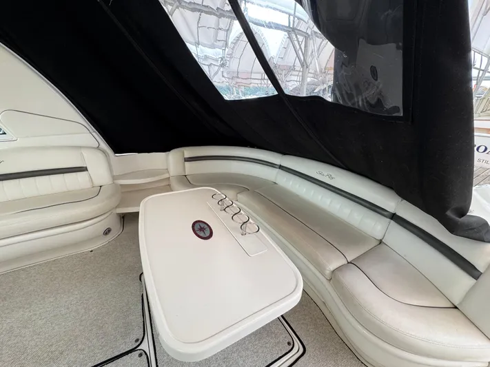 Dani Mar Yacht Photos Pics Interior of 2003 Sea Ray 500 Sundancer with white seating and table.