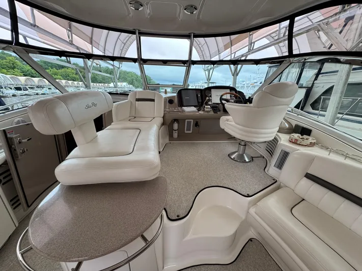Dani Mar Yacht Photos Pics Luxurious interior of 2003 Sea Ray 500 Sundancer yacht with plush seating and helm.