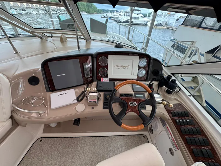 Dani Mar Yacht Photos Pics Helm of 2003 Sea Ray 500 Sundancer yacht with navigation equipment and steering wheel.