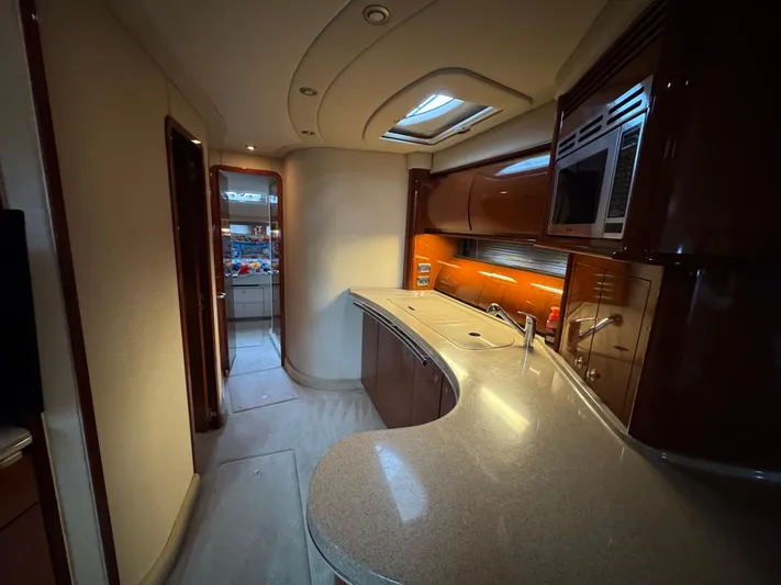 Dani Mar Yacht Photos Pics Luxurious interior of a 2003 Sea Ray 500 Sundancer yacht, featuring a modern kitchen area.