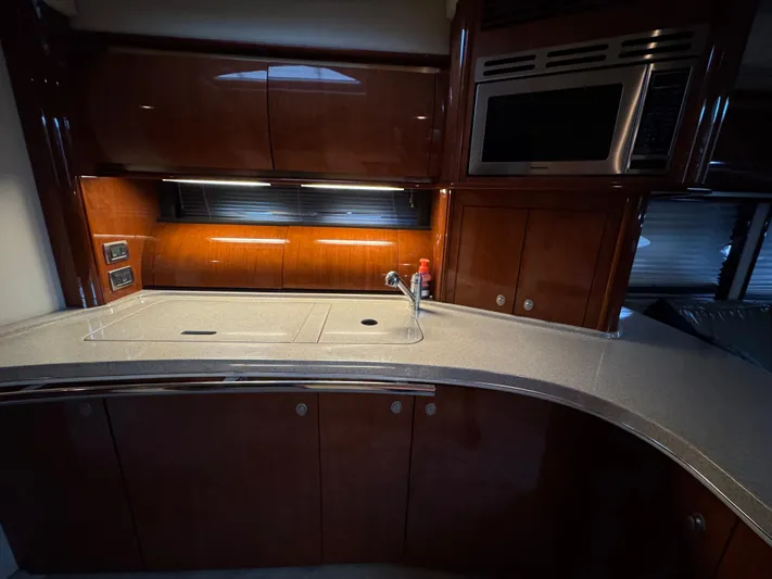 Dani Mar Yacht Photos Pics Luxurious kitchen area in a 2003 Sea Ray 500 Sundancer yacht with modern amenities.