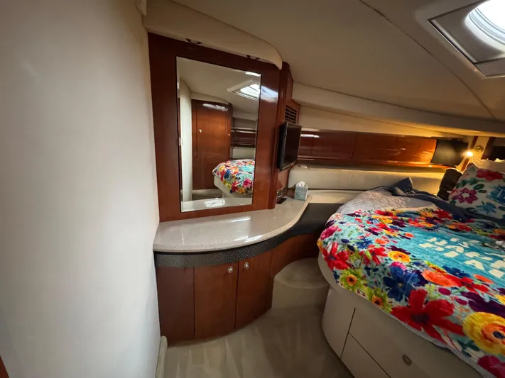 Dani Mar Yacht Photos Pics Interior of 2003 Sea Ray 500 Sundancer with floral bedding and wooden cabinetry.