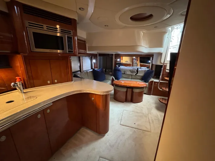 Dani Mar Yacht Photos Pics Luxurious interior of 2003 Sea Ray 500 Sundancer yacht with modern kitchen and cozy seating area.