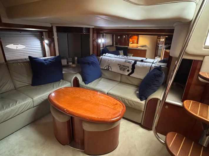 Dani Mar Yacht Photos Pics Luxurious interior of 2003 Sea Ray 500 Sundancer yacht with plush seating and elegant wood table.