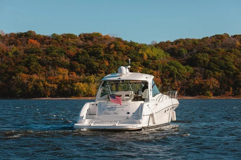 Dani Mar Yacht Photos Pics 2003 Sea Ray 500 Sundancer yacht cruising on a lake with autumn foliage backdrop.