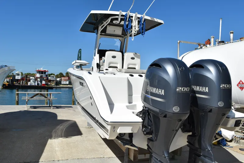  Yacht Photos Pics 2022 Pursuit S 268 Sport boat with dual Yamaha 200 engines docked by the water.