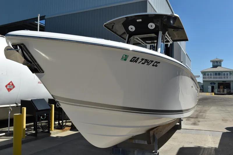  Yacht Photos Pics 2022 Pursuit S 268 Sport boat docked at a marina under clear blue skies.