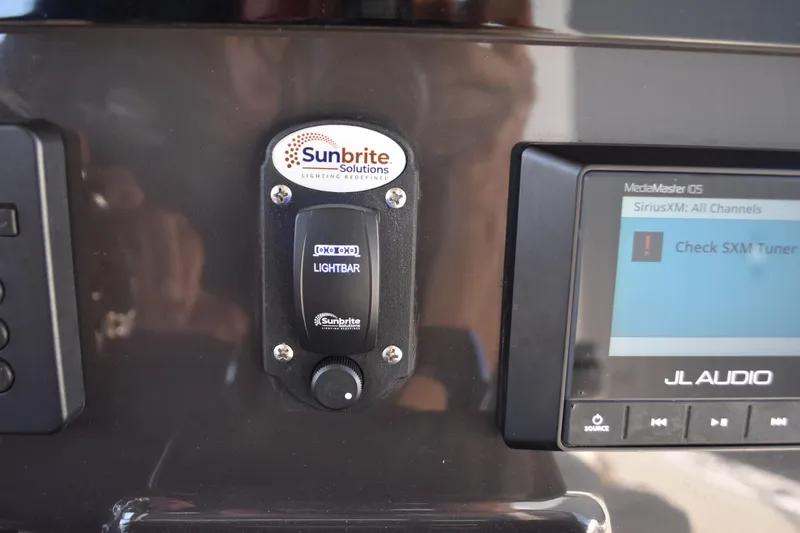  Yacht Photos Pics Control panel of 2022 Pursuit S 268 Sport with Sunbrite lightbar switch and JL Audio system.