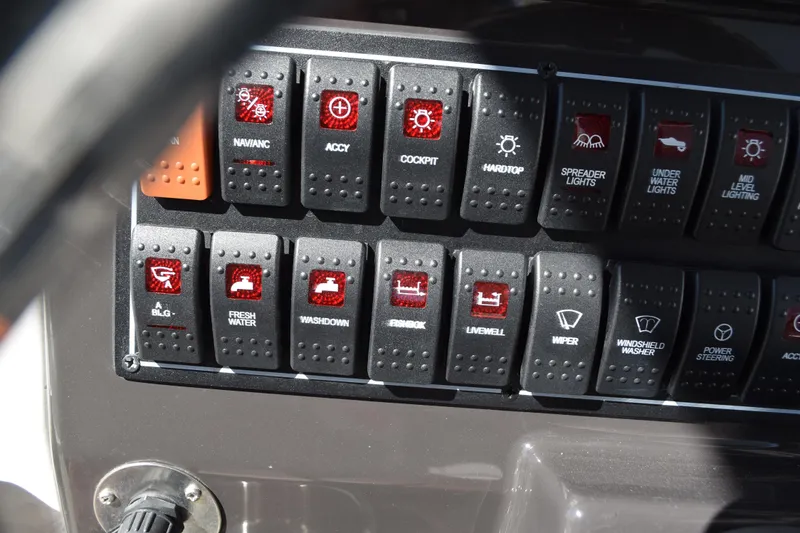  Yacht Photos Pics Control panel of a 2022 Pursuit S 268 Sport boat with labeled switches.