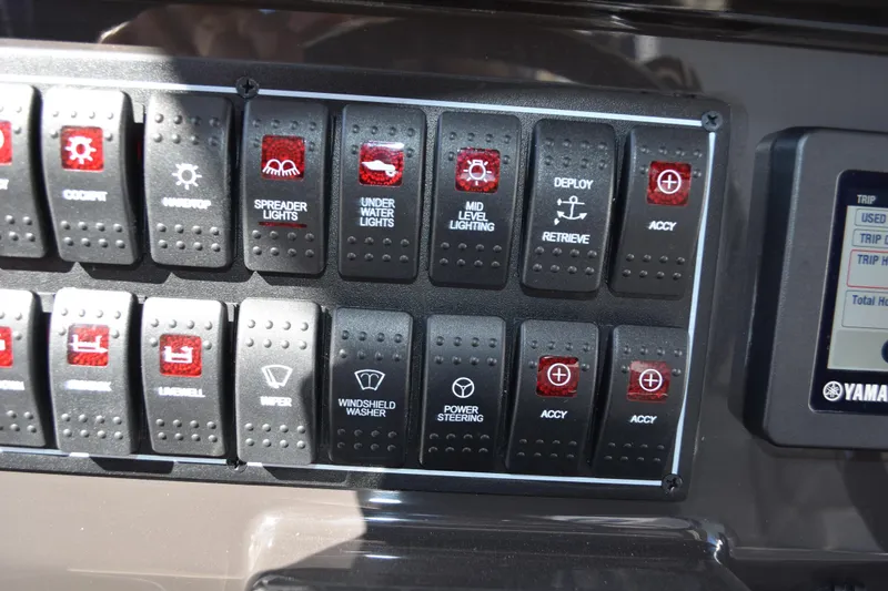  Yacht Photos Pics Control panel of 2022 Pursuit S 268 Sport boat with labeled switches and Yamaha display.