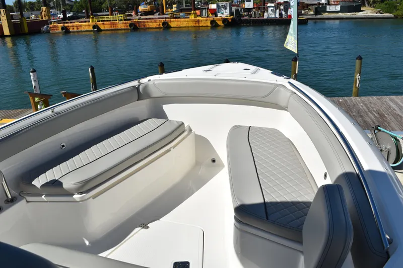  Yacht Photos Pics 2022 Pursuit S 268 Sport boat interior with cushioned seating by the water.