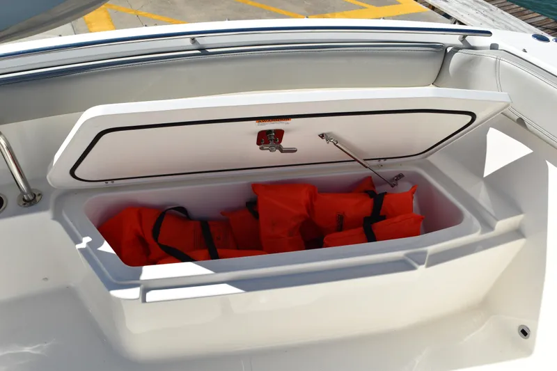 Yacht Photos Pics Open storage compartment on 2022 Pursuit S 268 Sport boat with orange life jackets.