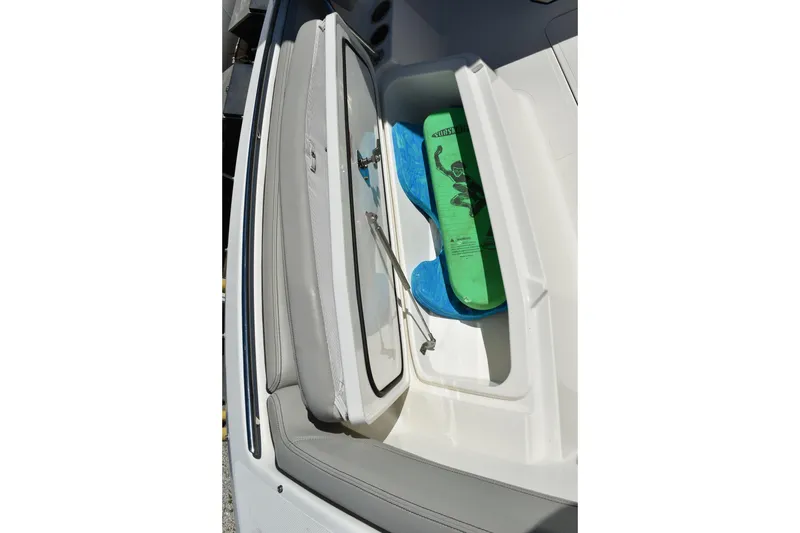  Yacht Photos Pics 2022 Pursuit S 268 Sport boat storage compartment with water sports equipment.