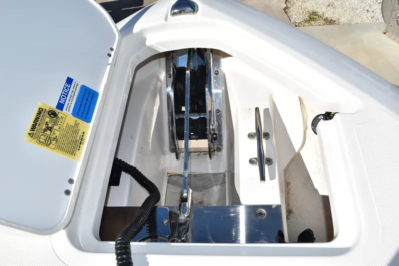  Yacht Photos Pics Anchor compartment of 2022 Pursuit S 268 Sport boat with visible winch and warning labels.
