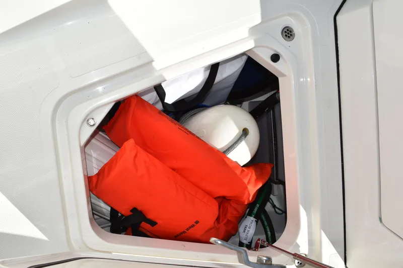  Yacht Photos Pics Storage compartment on 2022 Pursuit S 268 Sport boat with life jackets and buoy.