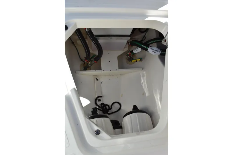  Yacht Photos Pics 2022 Pursuit S 268 Sport boat compartment with hoses and waste tank components.