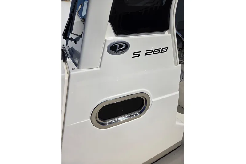  Yacht Photos Pics 2022 Pursuit S 268 Sport boat side view with logo and window detail.