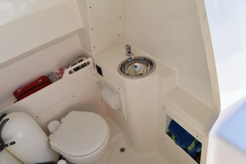  Yacht Photos Pics 2022 Pursuit S 268 Sport boat interior with toilet and sink.