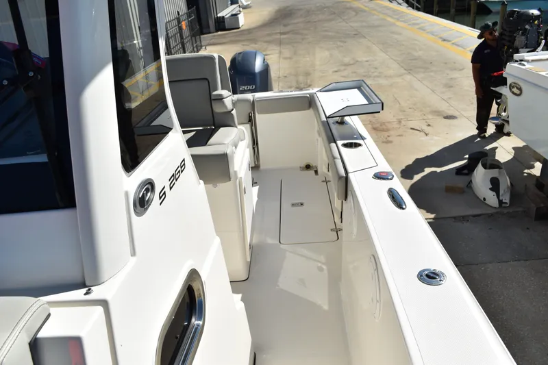  Yacht Photos Pics 2022 Pursuit S 268 Sport boat at dockside, showcasing spacious deck and seating.