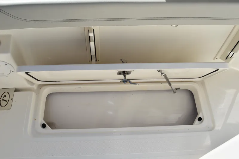  Yacht Photos Pics 2022 Pursuit S 268 Sport boat storage compartment with open hatch.