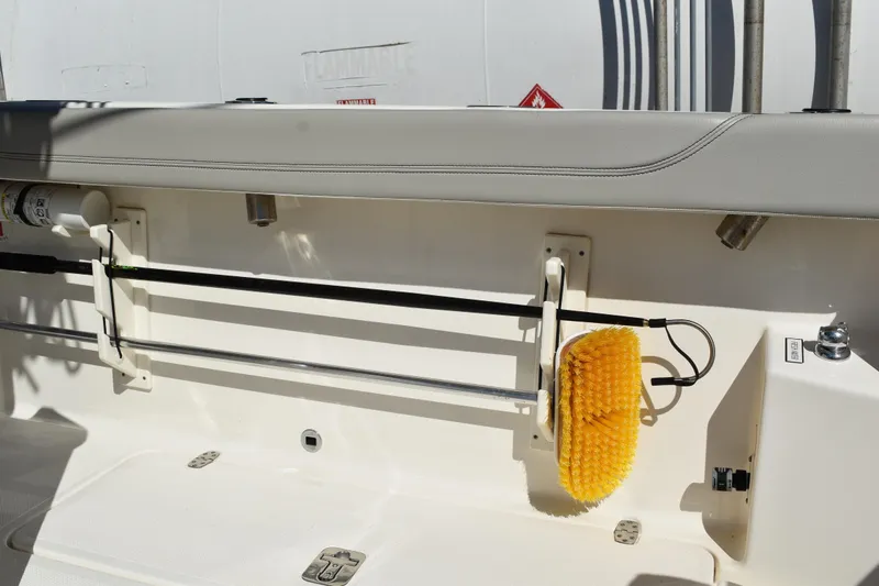  Yacht Photos Pics 2022 Pursuit S 268 Sport boat interior with mounted cleaning brush and equipment.