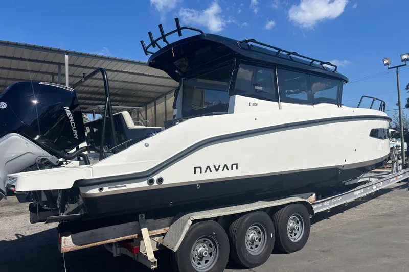  Yacht Photos Pics 2026 Navan C30 boat on trailer with Mercury engine, parked outdoors under clear sky.