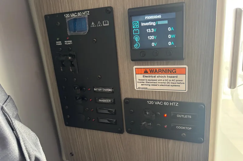  Yacht Photos Pics Electrical control panel in a 2026 Navan C30, featuring inverter and warning label.