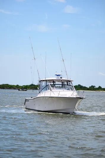 Sur Reel Yacht Photos Pics 2003 Grady-White Express 330 boat cruising on a sunny day.