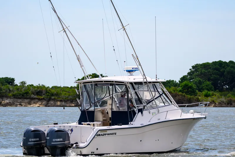 Sur Reel Yacht Photos Pics 2003 Grady-White Express 330 boat on water with fishing rods and Yamaha engines.