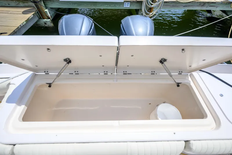 Sur Reel Yacht Photos Pics Open storage compartment on a 2003 Grady-White Express 330 boat, docked by the water.