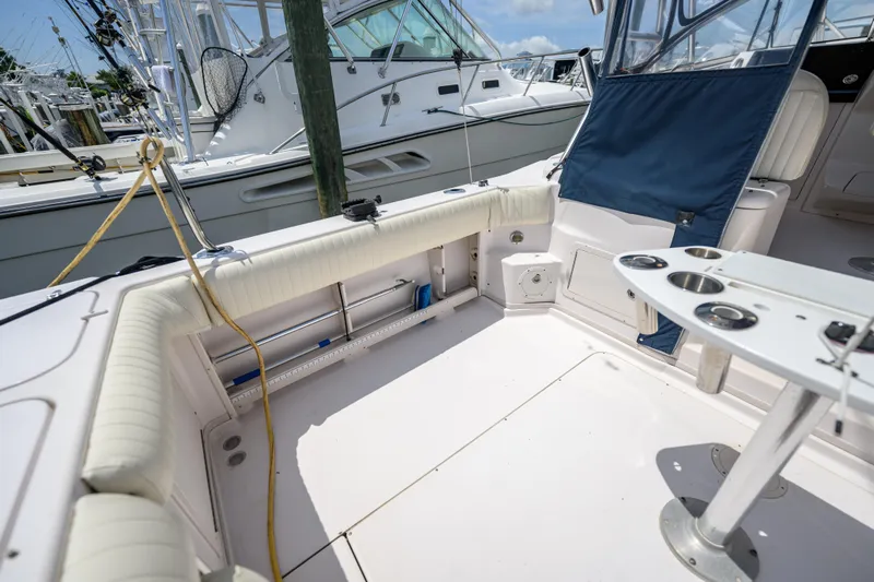 Sur Reel Yacht Photos Pics 2003 Grady-White Express 330 boat interior with seating and fishing rod holders.