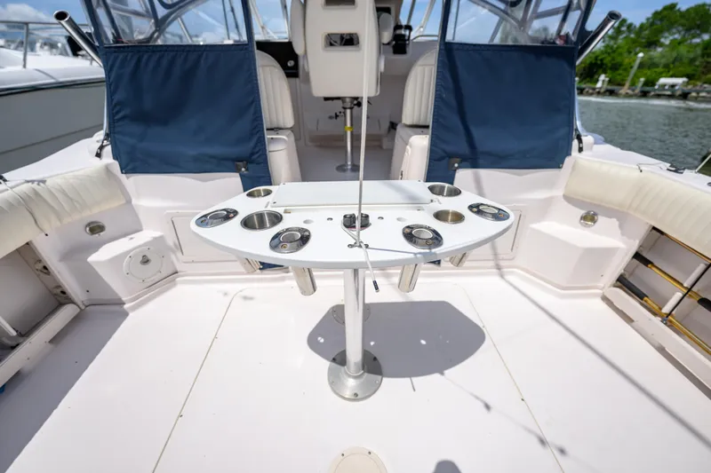 Sur Reel Yacht Photos Pics 2003 Grady-White Express 330 boat interior with fishing rod holders and seating.