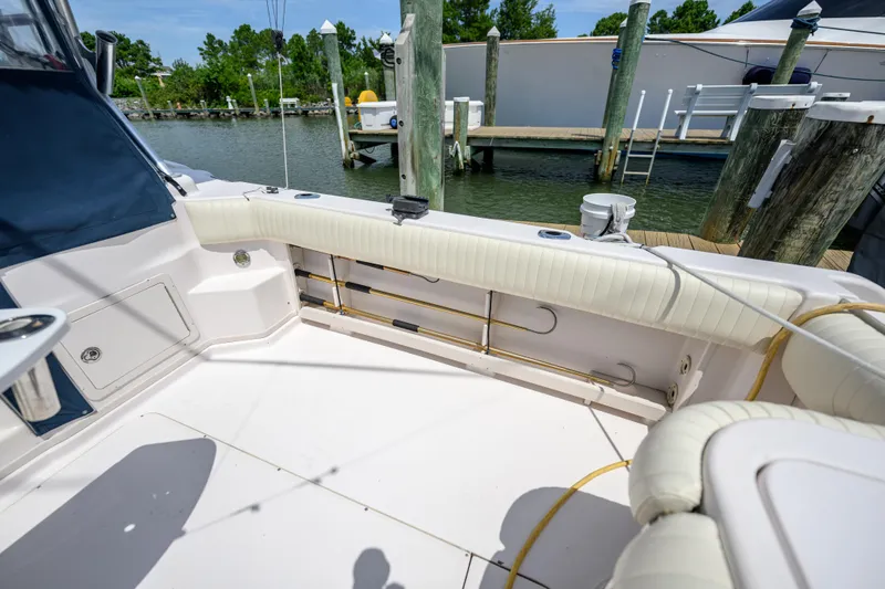Sur Reel Yacht Photos Pics 2003 Grady-White Express 330 boat interior, featuring cushioned seating and dockside view.