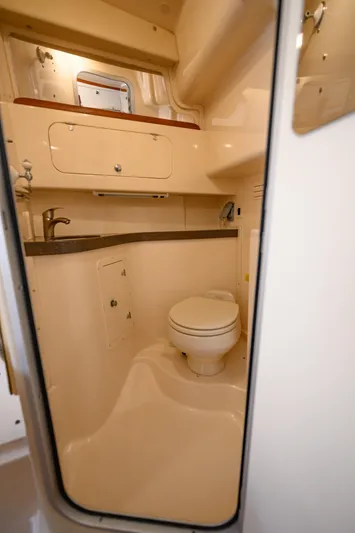 Sur Reel Yacht Photos Pics 2003 Grady-White Express 330 boat bathroom with sink, toilet, and storage cabinet.