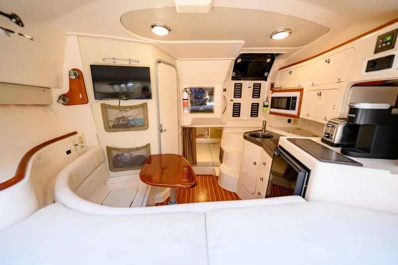 Sur Reel Yacht Photos Pics Interior of 2003 Grady-White Express 330 boat, featuring kitchen, seating, and modern amenities.