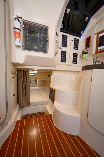 Sur Reel Yacht Photos Pics Interior of 2003 Grady-White Express 330 boat, featuring cabin, control panel, and wooden flooring.