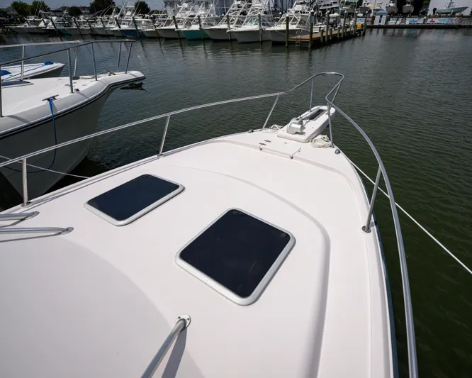 Sur Reel Yacht Photos Pics 2003 Grady-White Express 330 boat docked at marina, showing bow and hatches.