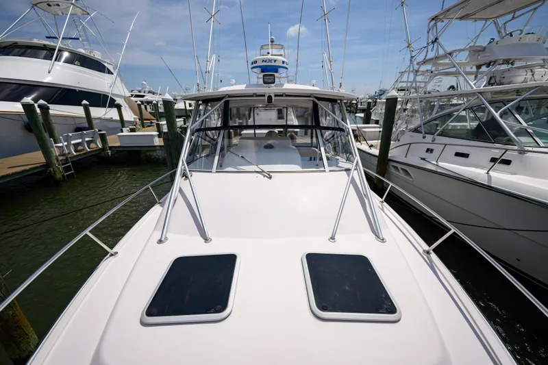 Sur Reel Yacht Photos Pics 2003 Grady-White Express 330 boat docked at marina, surrounded by other vessels.