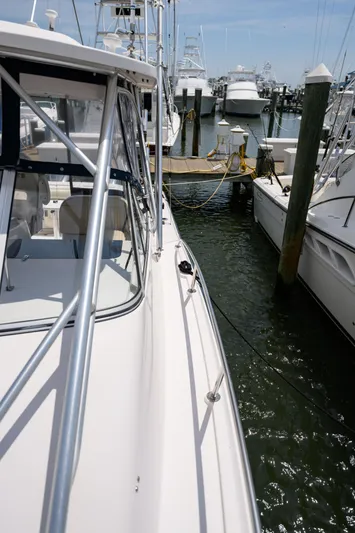 Sur Reel Yacht Photos Pics 2003 Grady-White Express 330 docked at a marina, surrounded by other boats.