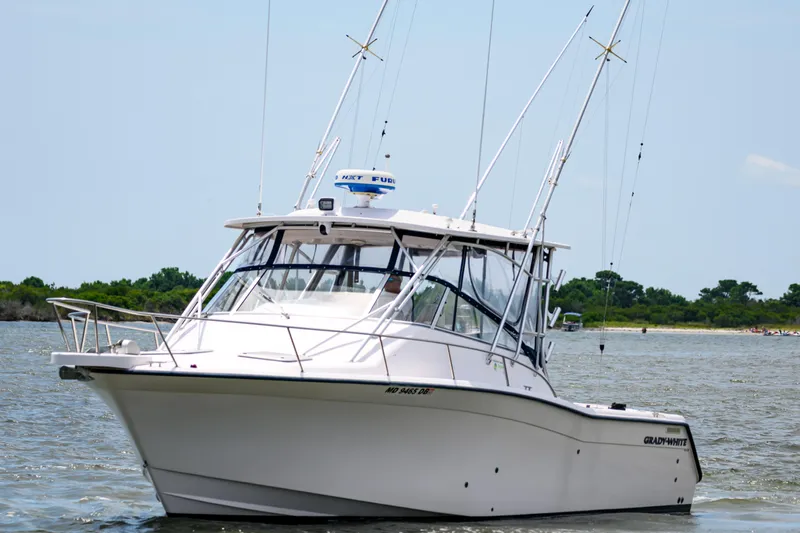 Sur Reel Yacht Photos Pics 2003 Grady-White Express 330 boat on water, featuring fishing rods and radar equipment.
