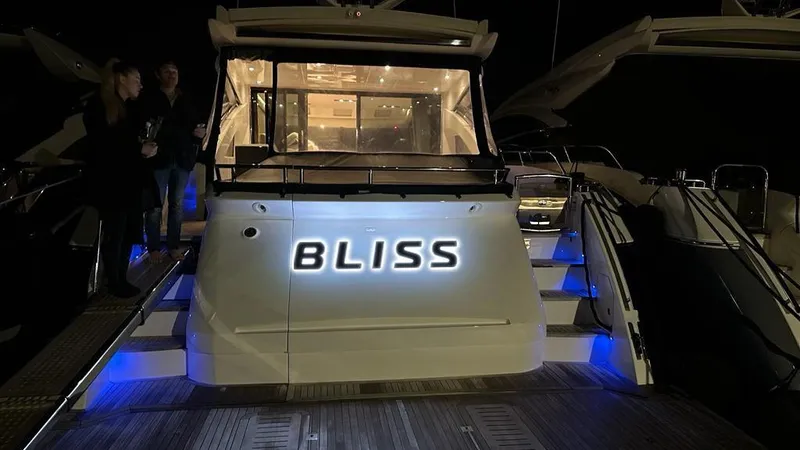 Bliss Yacht Photos Pics 2015 Princess V72 yacht "Bliss" illuminated at night with blue accent lighting.