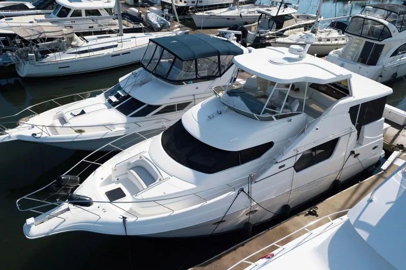 Lola's Ark III Yacht Photos Pics 2001 Silverton 453 Motor Yacht docked among other boats in a marina.