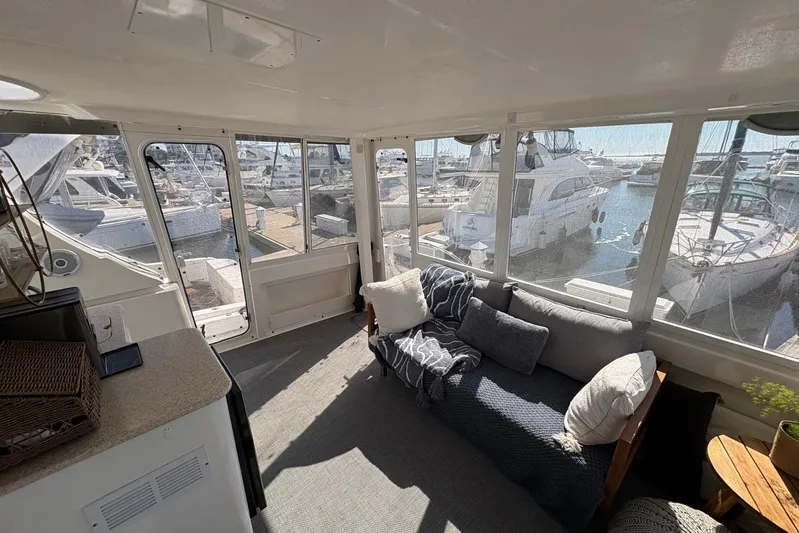 Lola's Ark III Yacht Photos Pics Interior of 2001 Silverton 453 Motor Yacht with cozy seating and marina view.