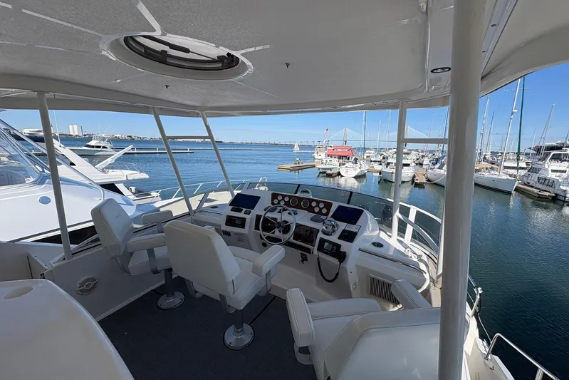 Lola's Ark III Yacht Photos Pics 2001 Silverton 453 Motor Yacht helm overlooking marina with clear blue skies.